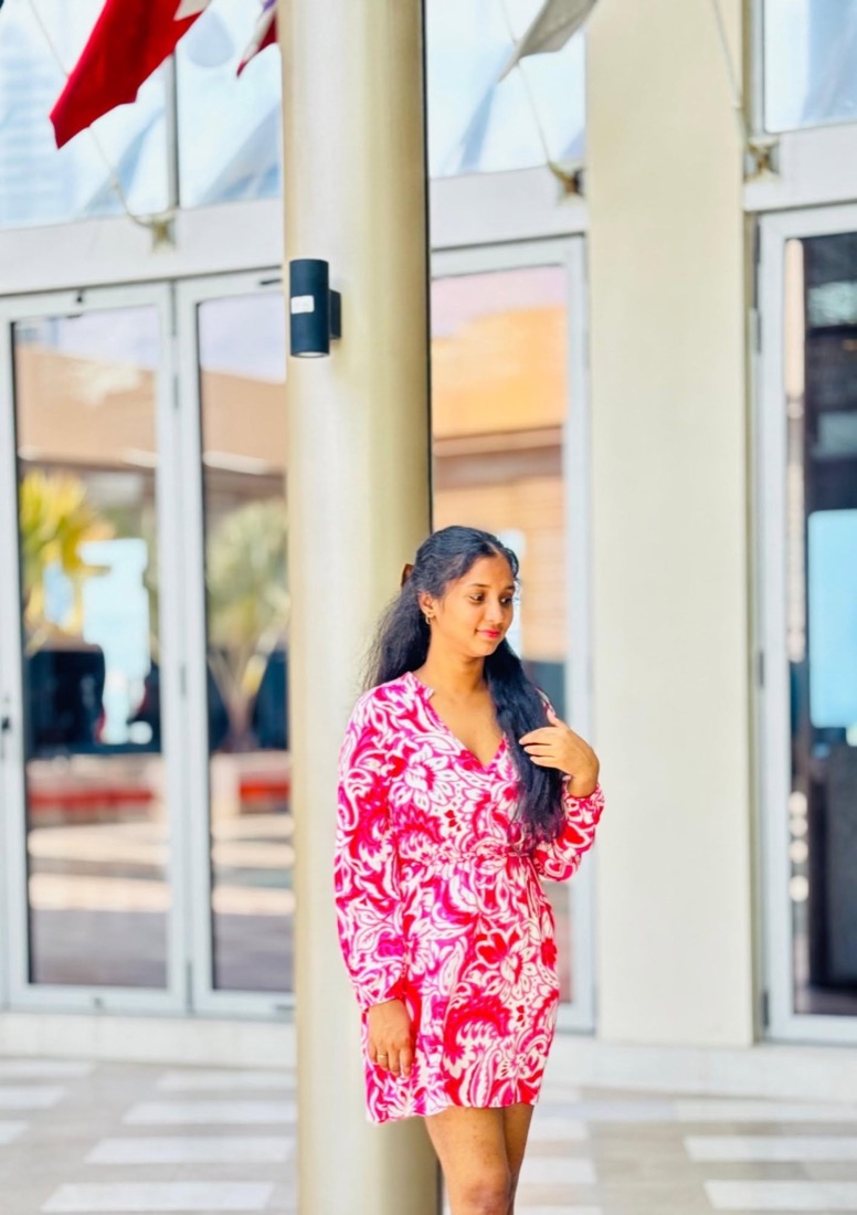 Thaara in a pink and white dress