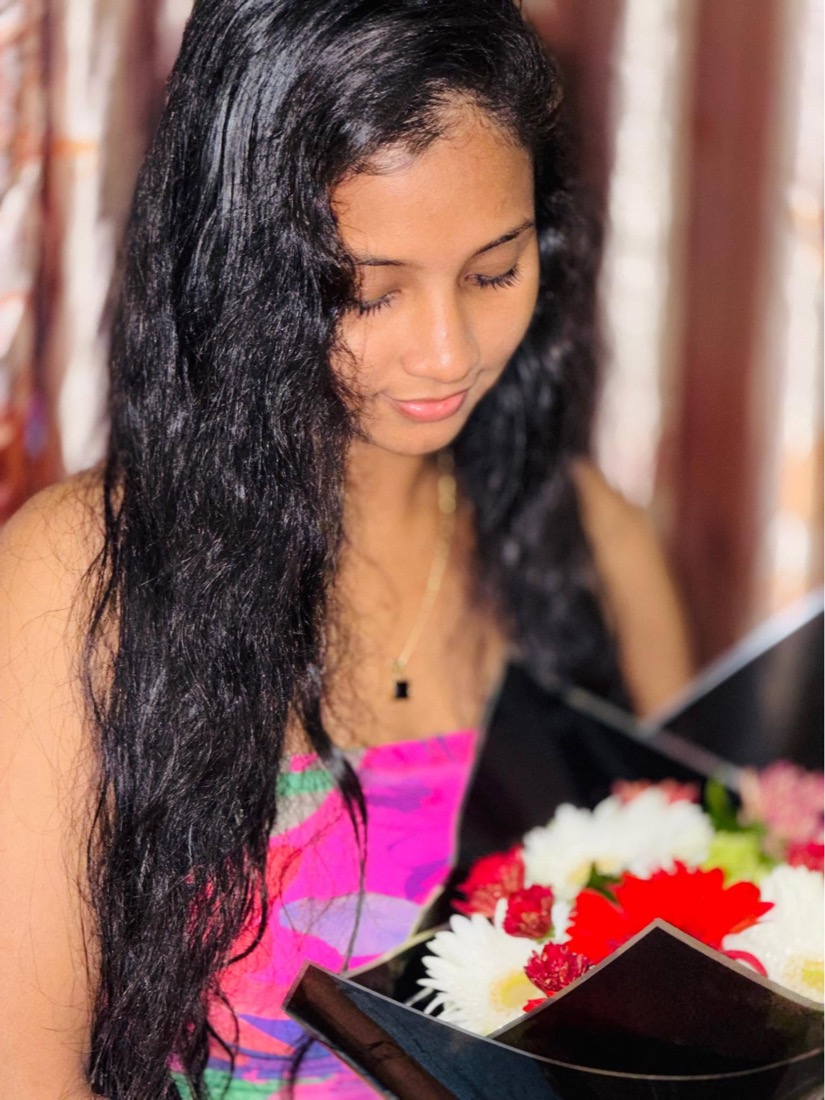 Thaara holding a bouquet of flowers