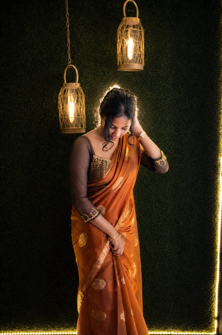 Thaara in a saree under warm lanterns